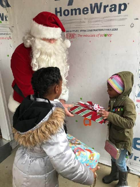 Santa stopped by one of the Habitat homes still under construction on Brooks Lane on December 14th to deliver presents to the children of Habitat homebuyers.
